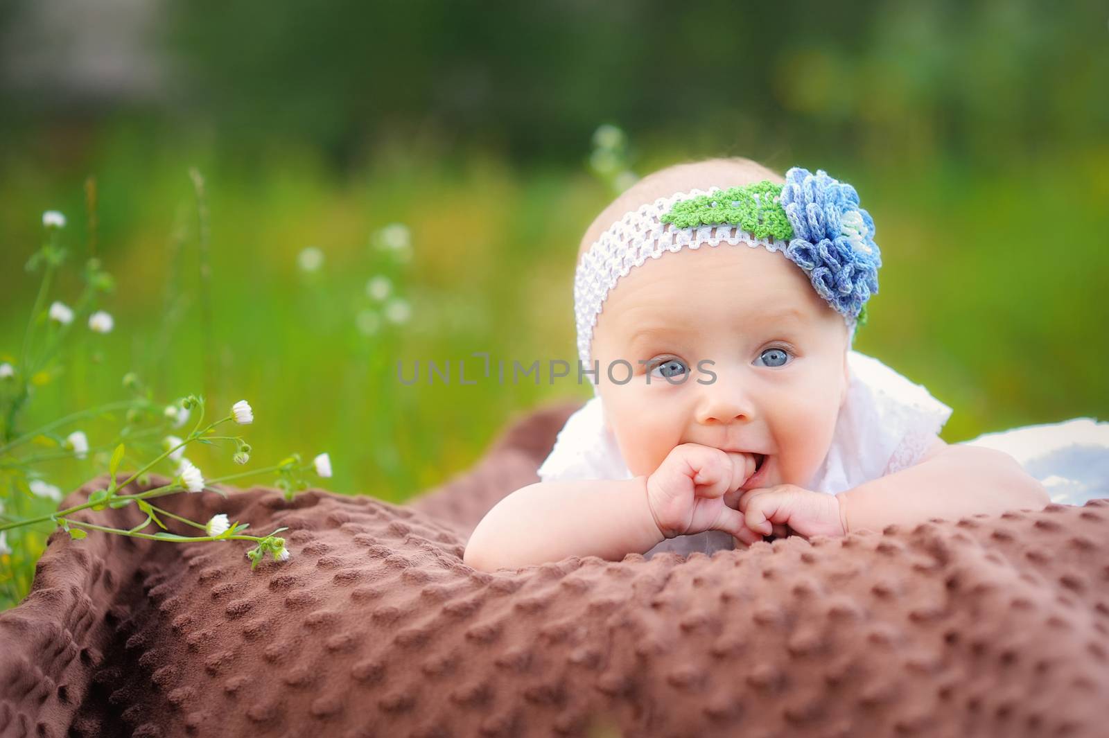 Cute little girl on the meadow in summer day 