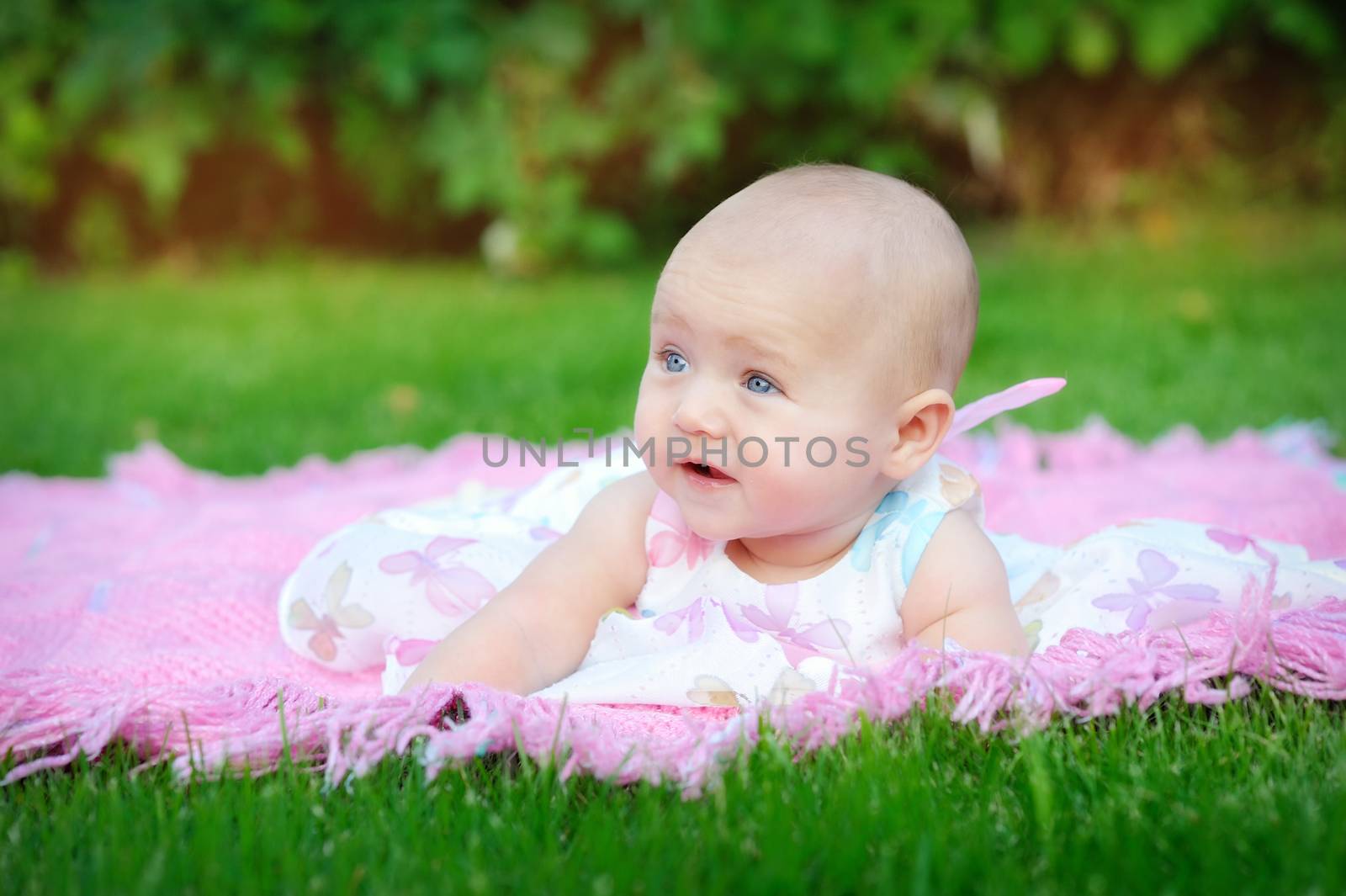 Cute little girl on the meadow in spring day 