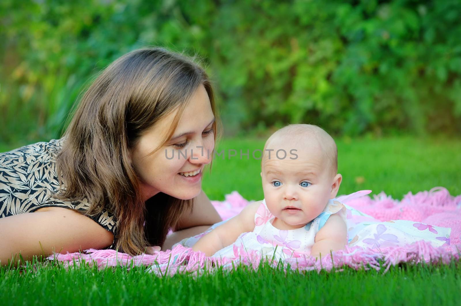 Portrait of happy loving mother and her baby outdoors  by timonko