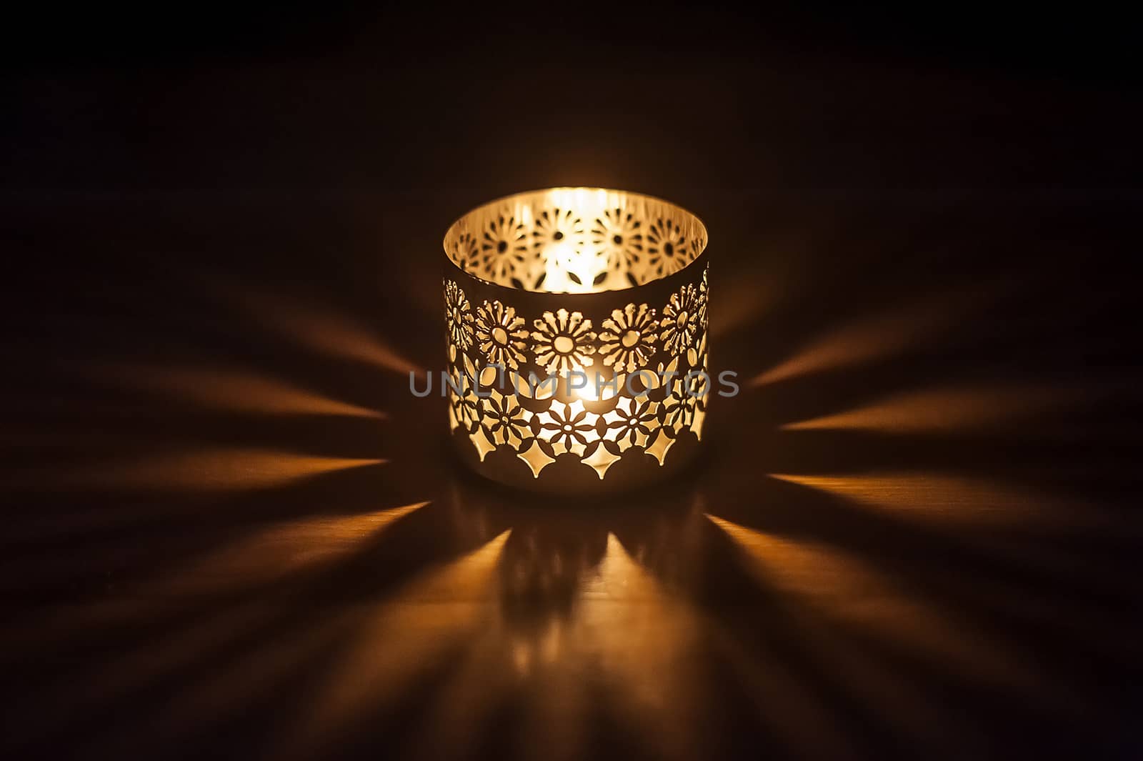 lighted candle in a candlestick