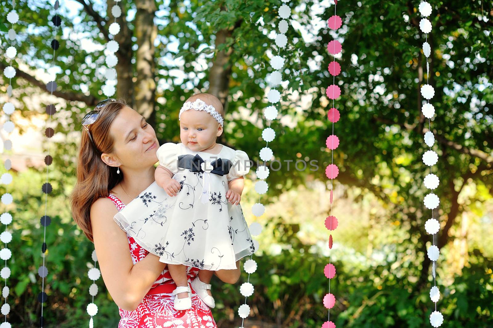 Beautiful Mother And Baby playing in a park. outdoors. Nature.  by timonko