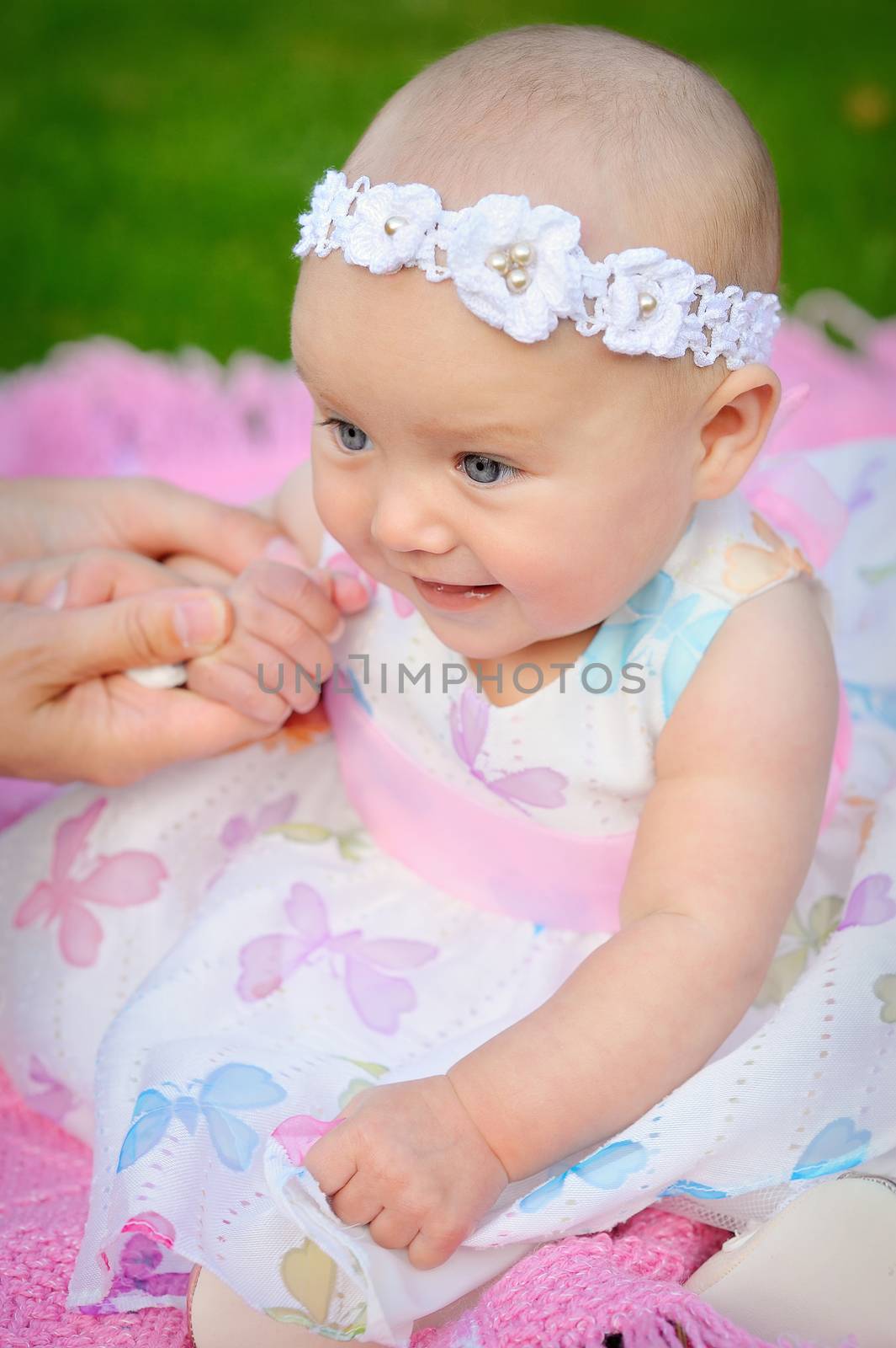 happy smiling cheerful baby girl in pink hood with ears 