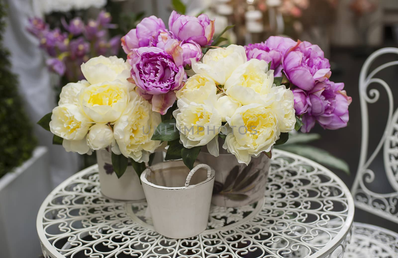 bouquet of pink peonies in vase on table  by timonko