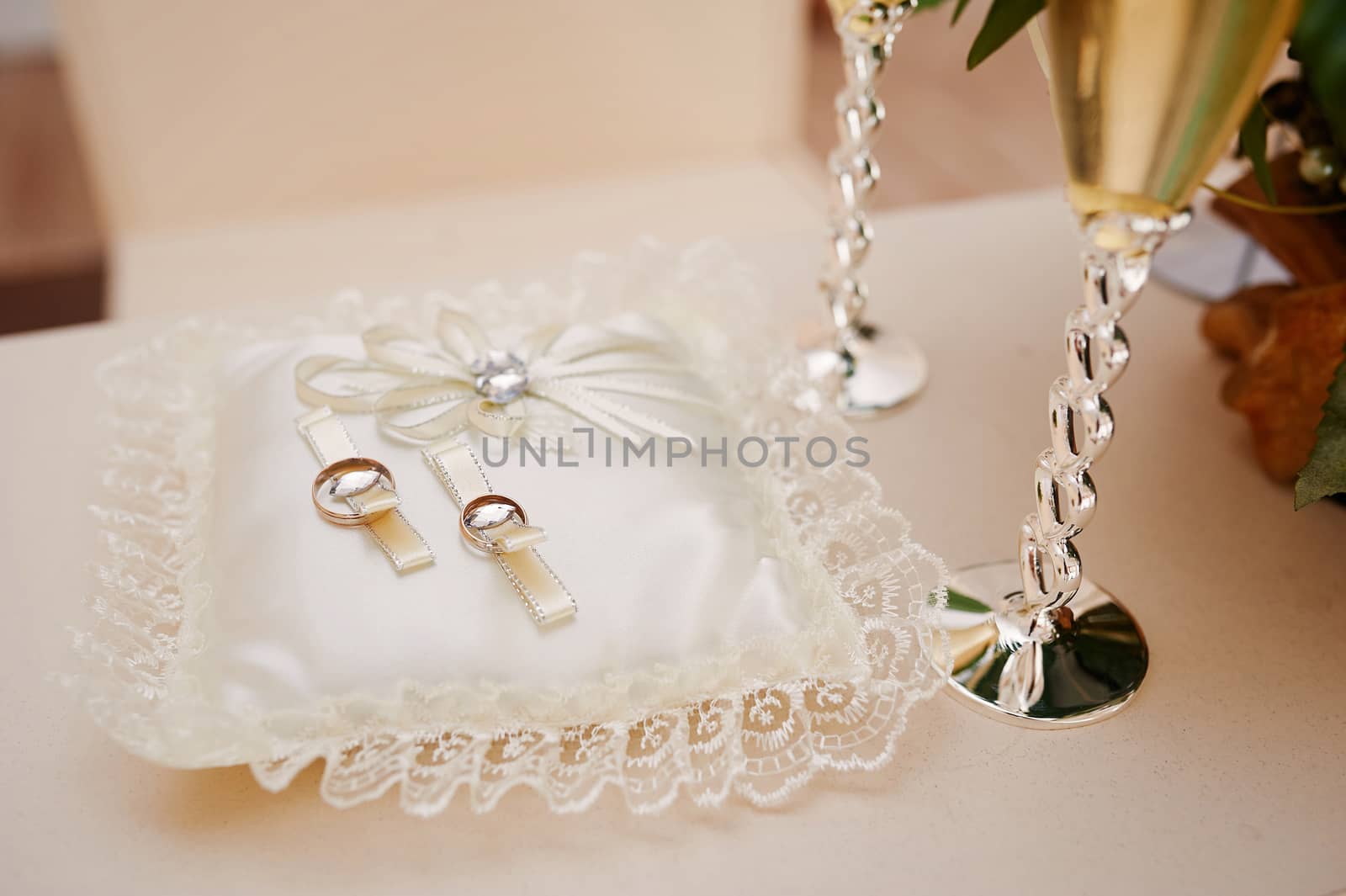 two gold rings on the pillow for the ceremony.