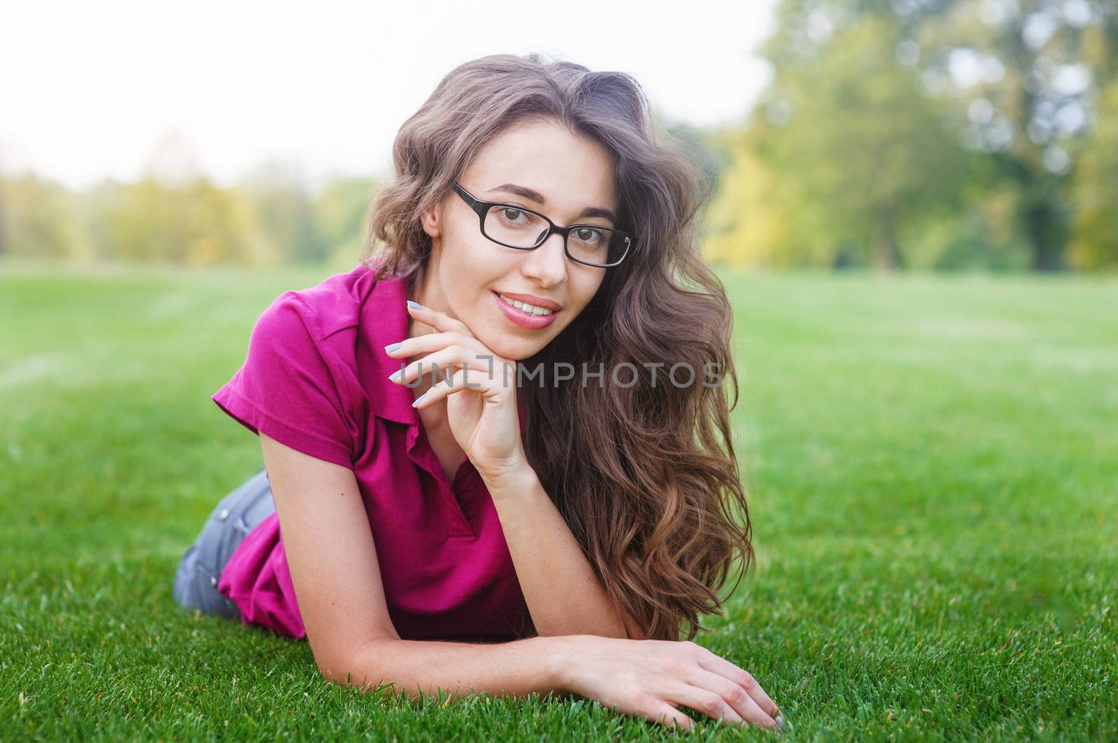 beautiful woman lying on the grass in the Park by timonko