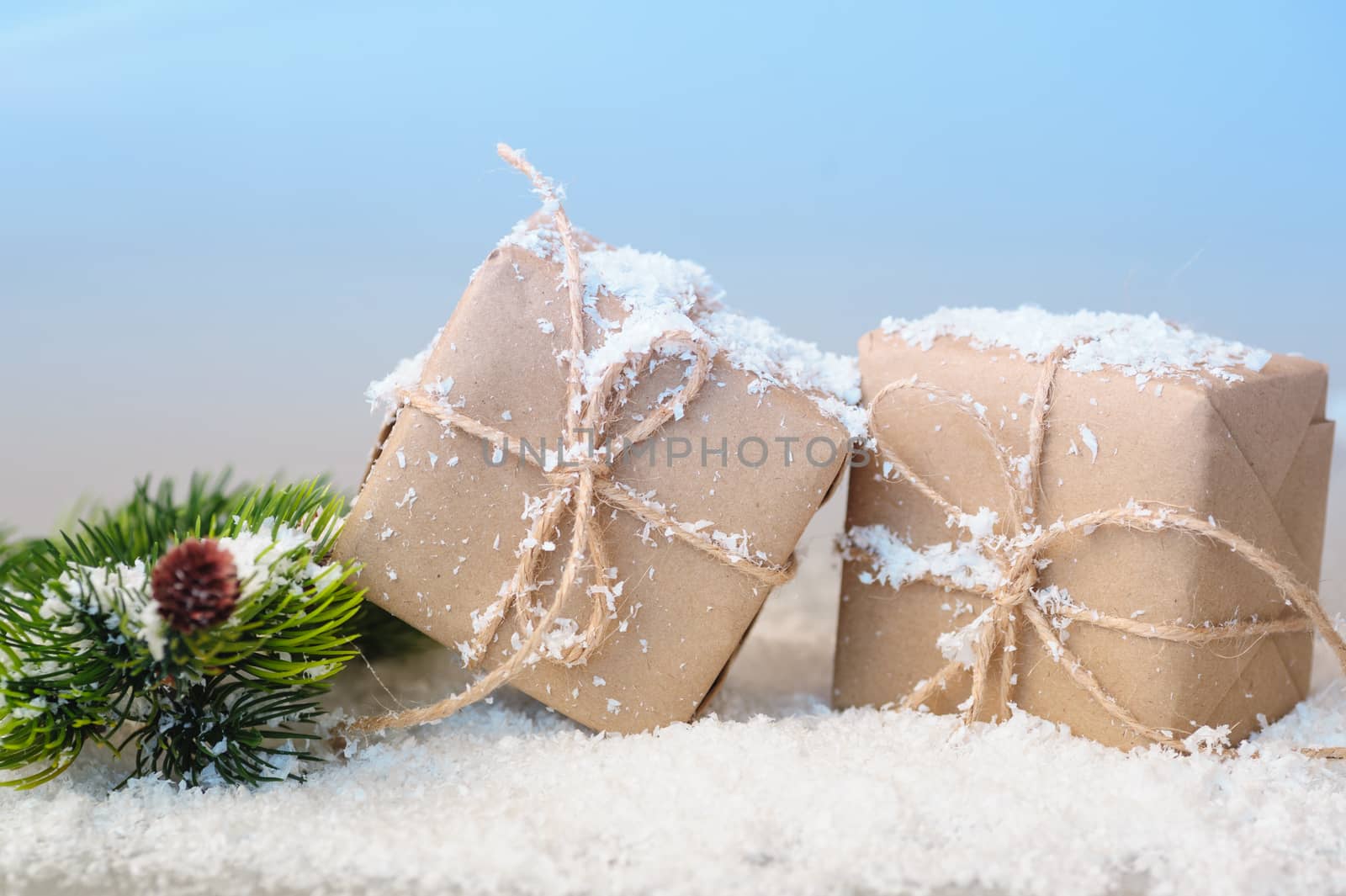 gift boxes of kraft paper with spruce branches on white background.