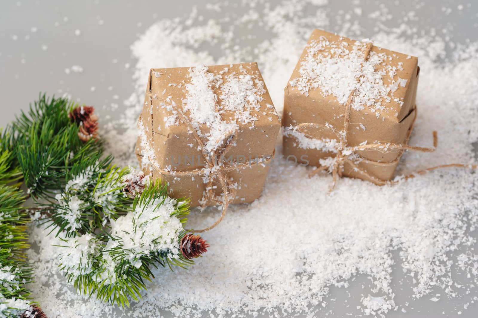 gift boxes of kraft paper with spruce branches on white background.