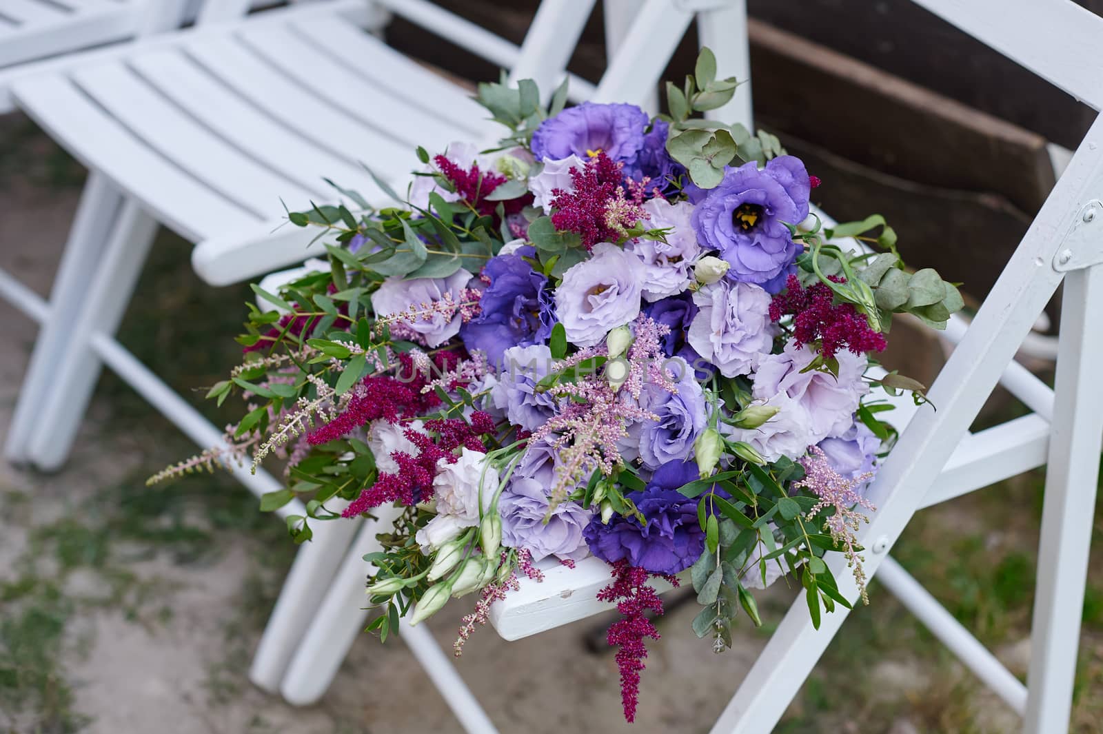 beautiful wedding bouquet the bride on a Chair for the ceremony by timonko