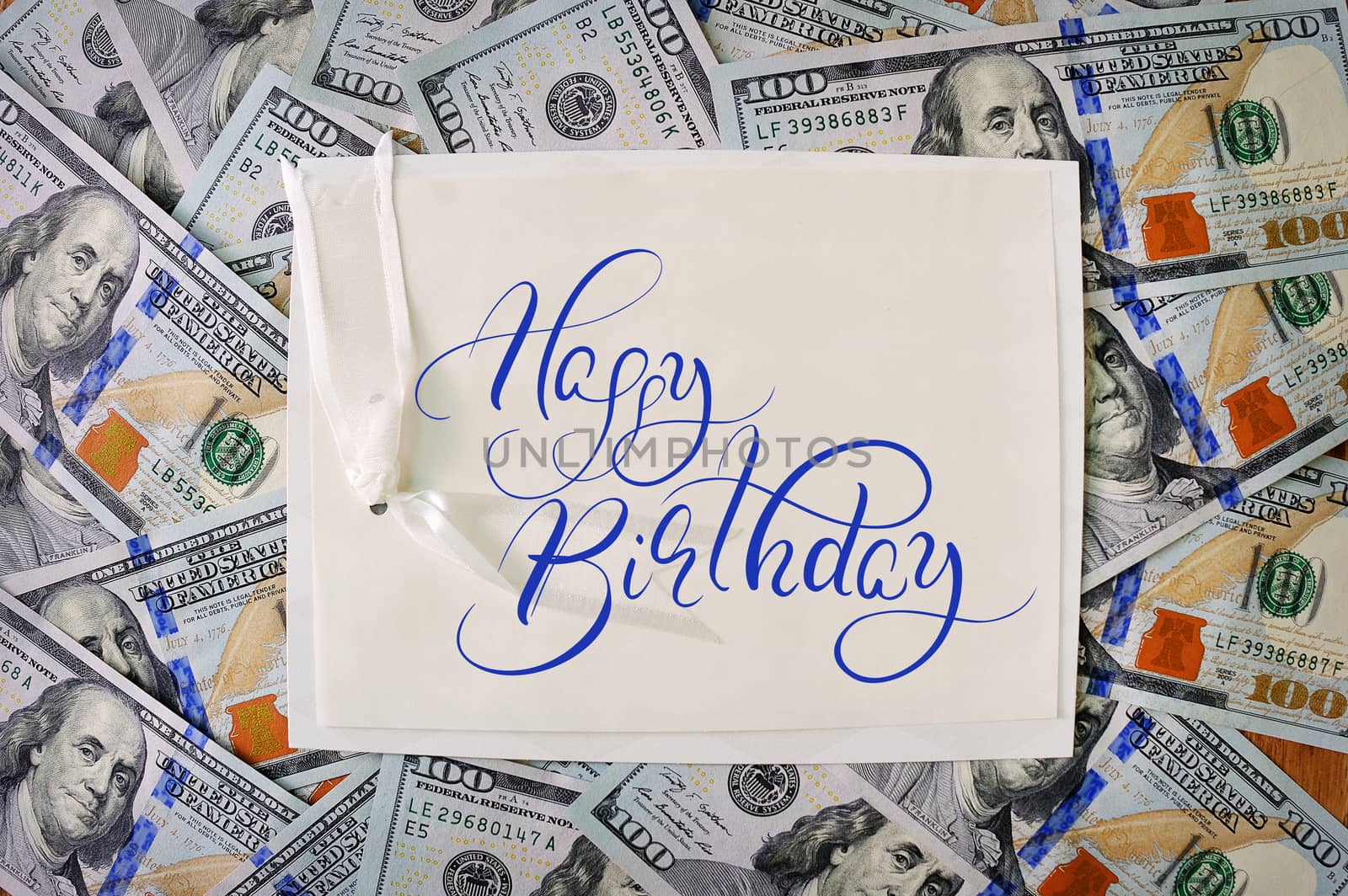 big pile of money. stack of american dollars backgrounds with text Happy Birthday. Calligraphy lettering.