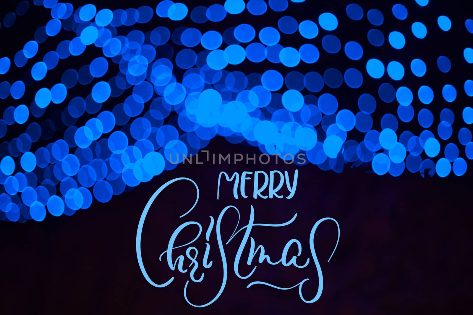 Blue blur Garland in Winter Park Christmas Decor with text Merry Christmas. Calligraphy and lettering.