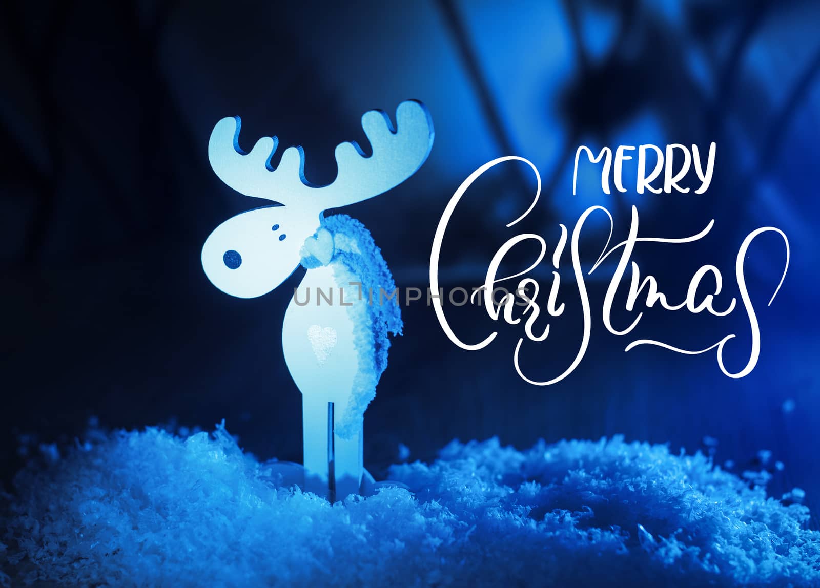 White toy Moose and Merry Christmas text. Calligraphy lettering.