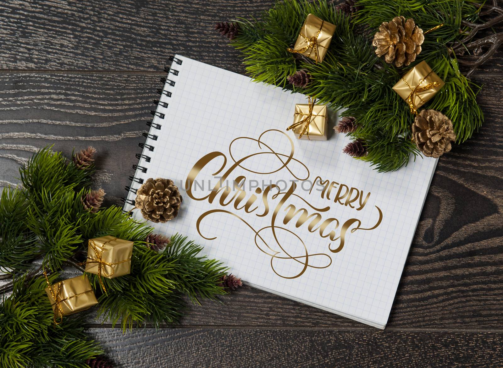 background of tree branches and space for greetings with text Merry Christmas. Calligraphy lettering.