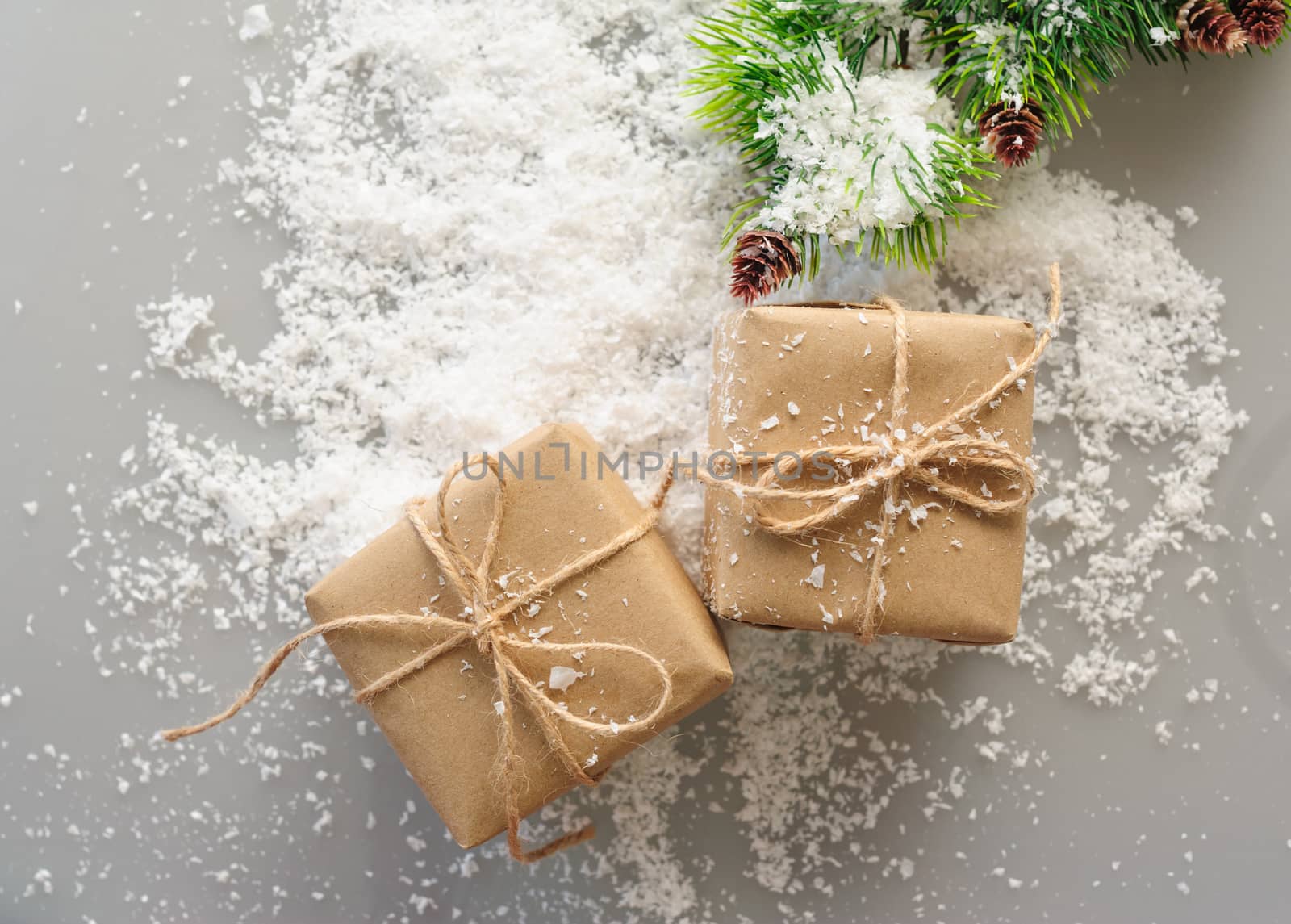 gift boxes of kraft paper with spruce branches on white background