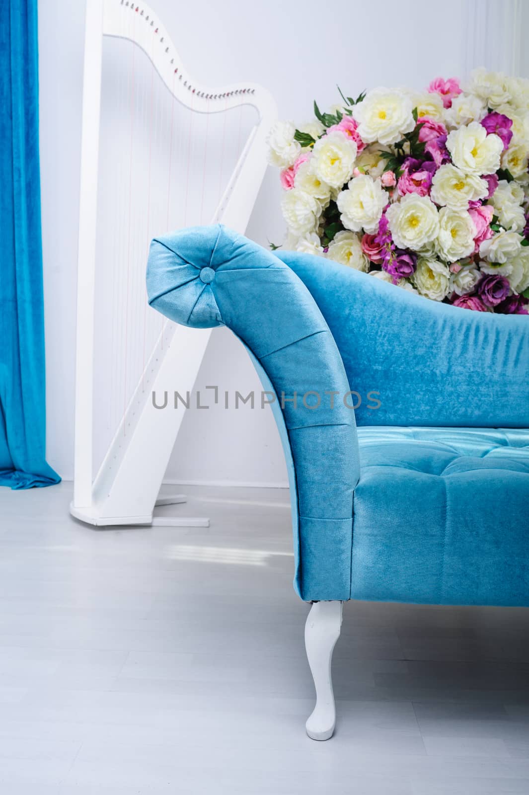 Turquoise sofa and a bouquet of flowers in the Studio.