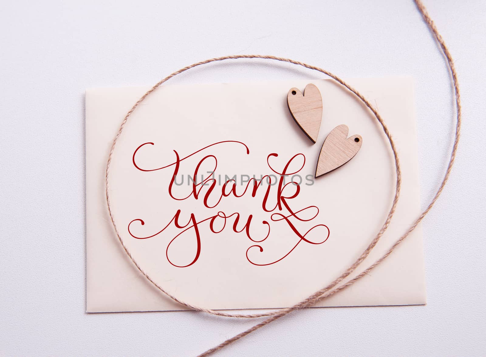 Valentines card with wooden heart and text Thank you.