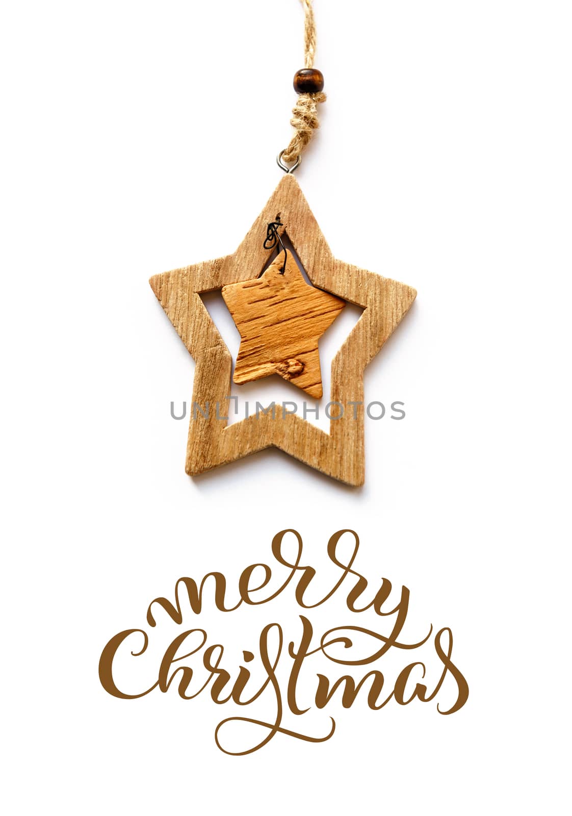 Wooden Toy star on a white background and text Merry Christmas. Calligraphy lettering.