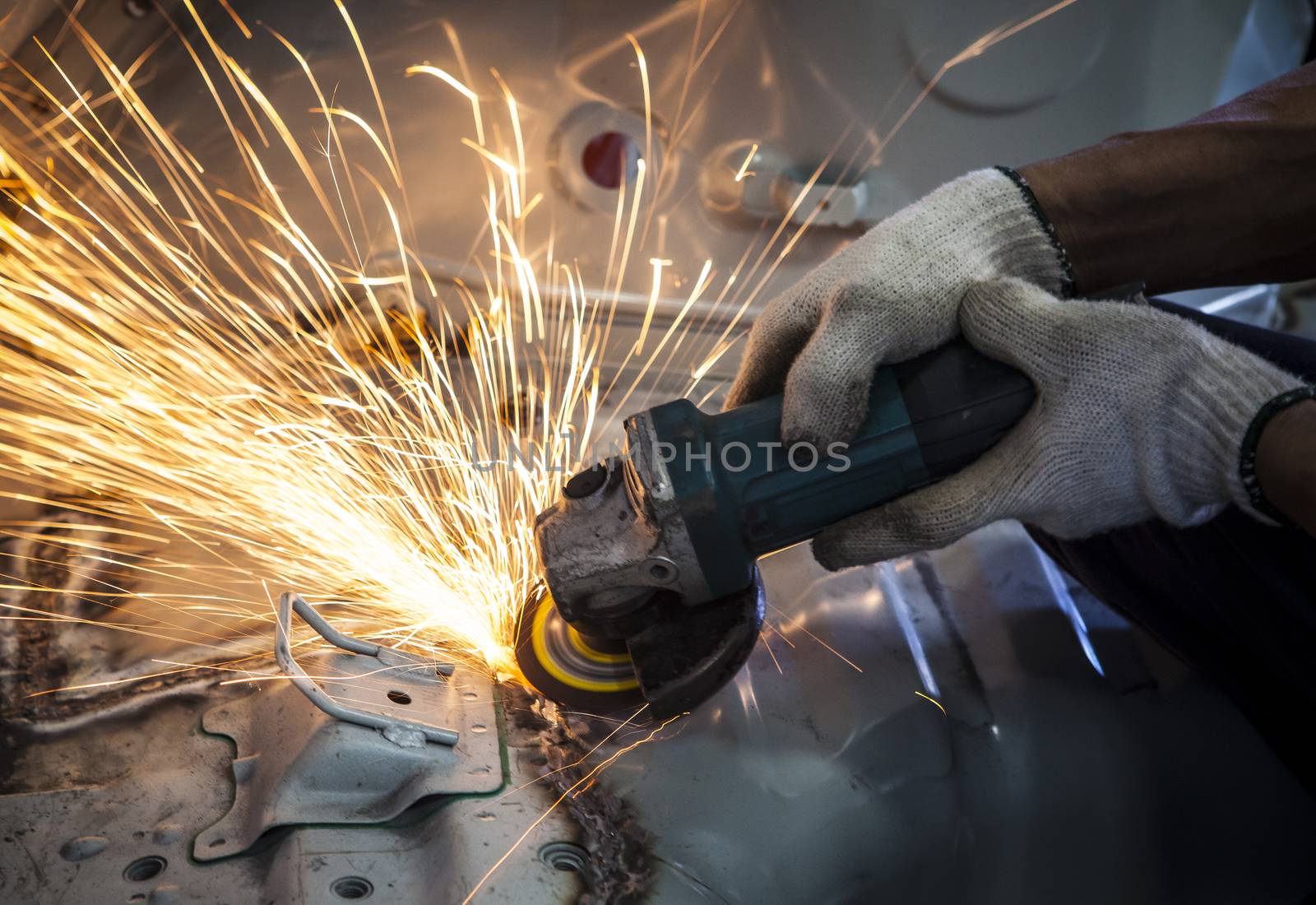 worker hand working by industry tool cutting steel with split fi by khunaspix