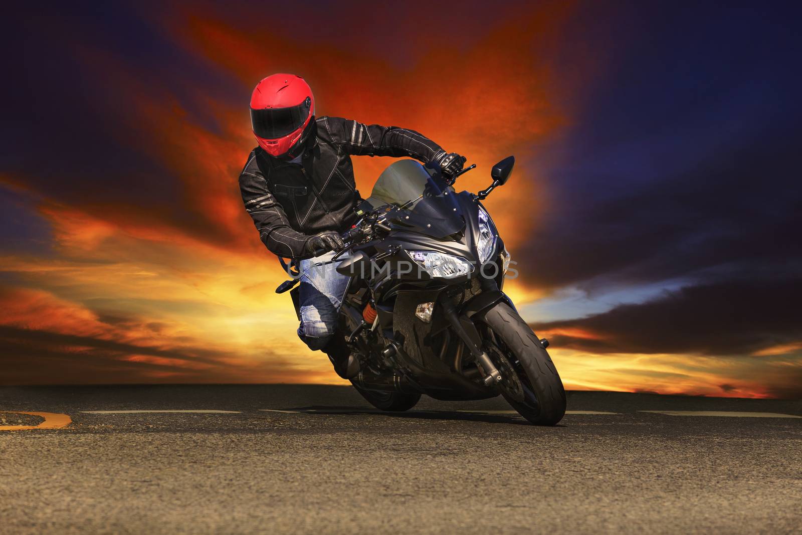 young man riding big bike motorcycle on asphalt roads against be by khunaspix