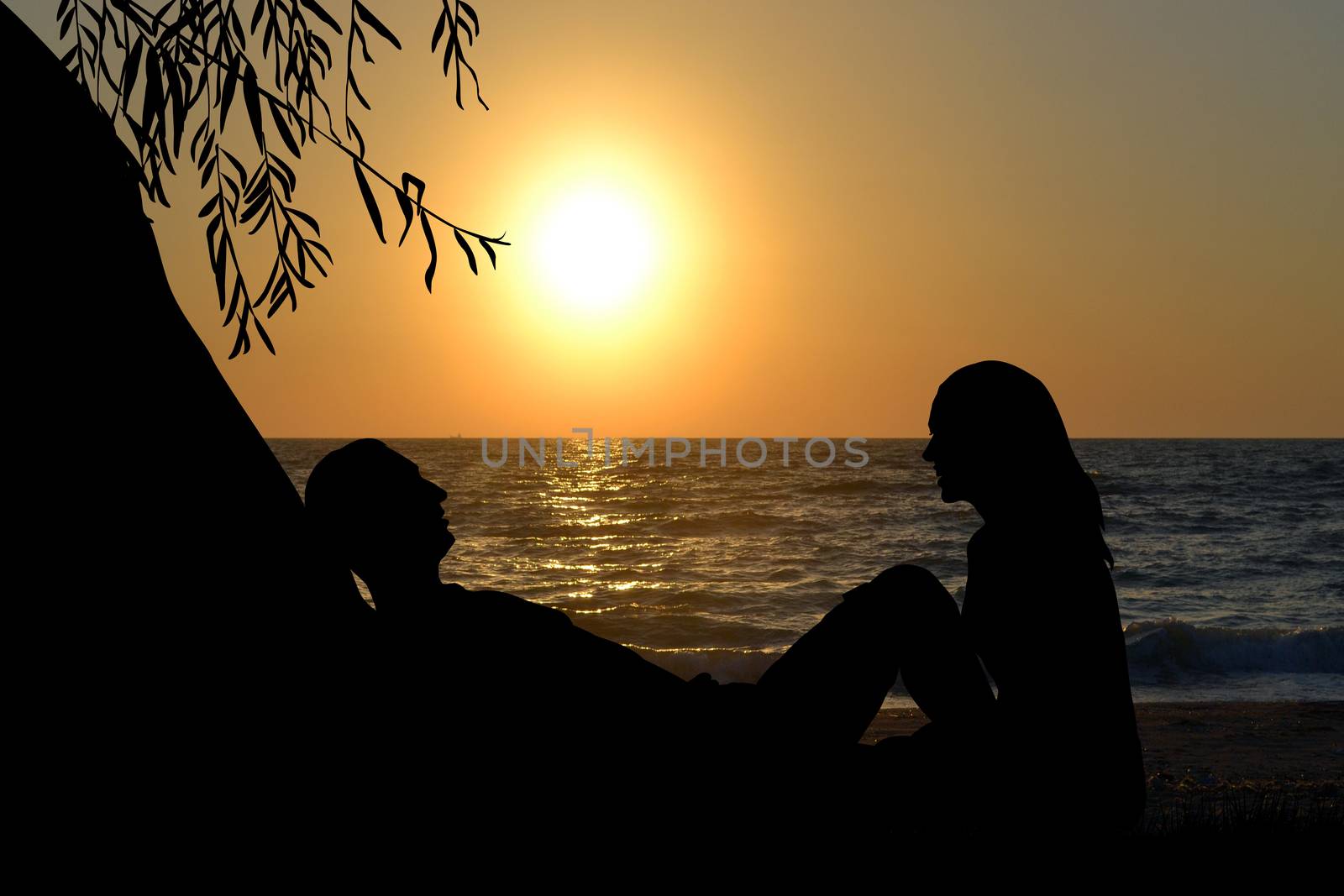 Romantic couple near the sea at sunrise