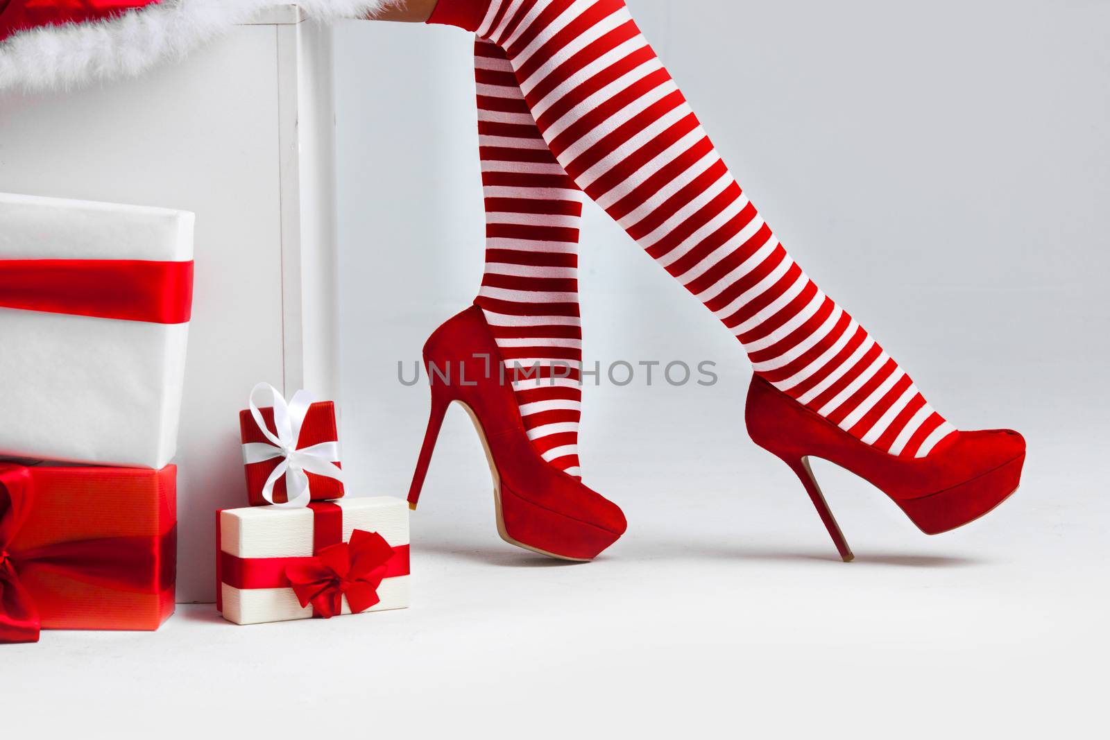 Santa woman legs and christmas gifts, Christmas shopping concept