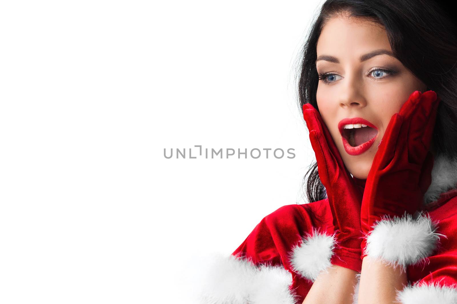 Surprised young woman in santa claus costume isolated on white