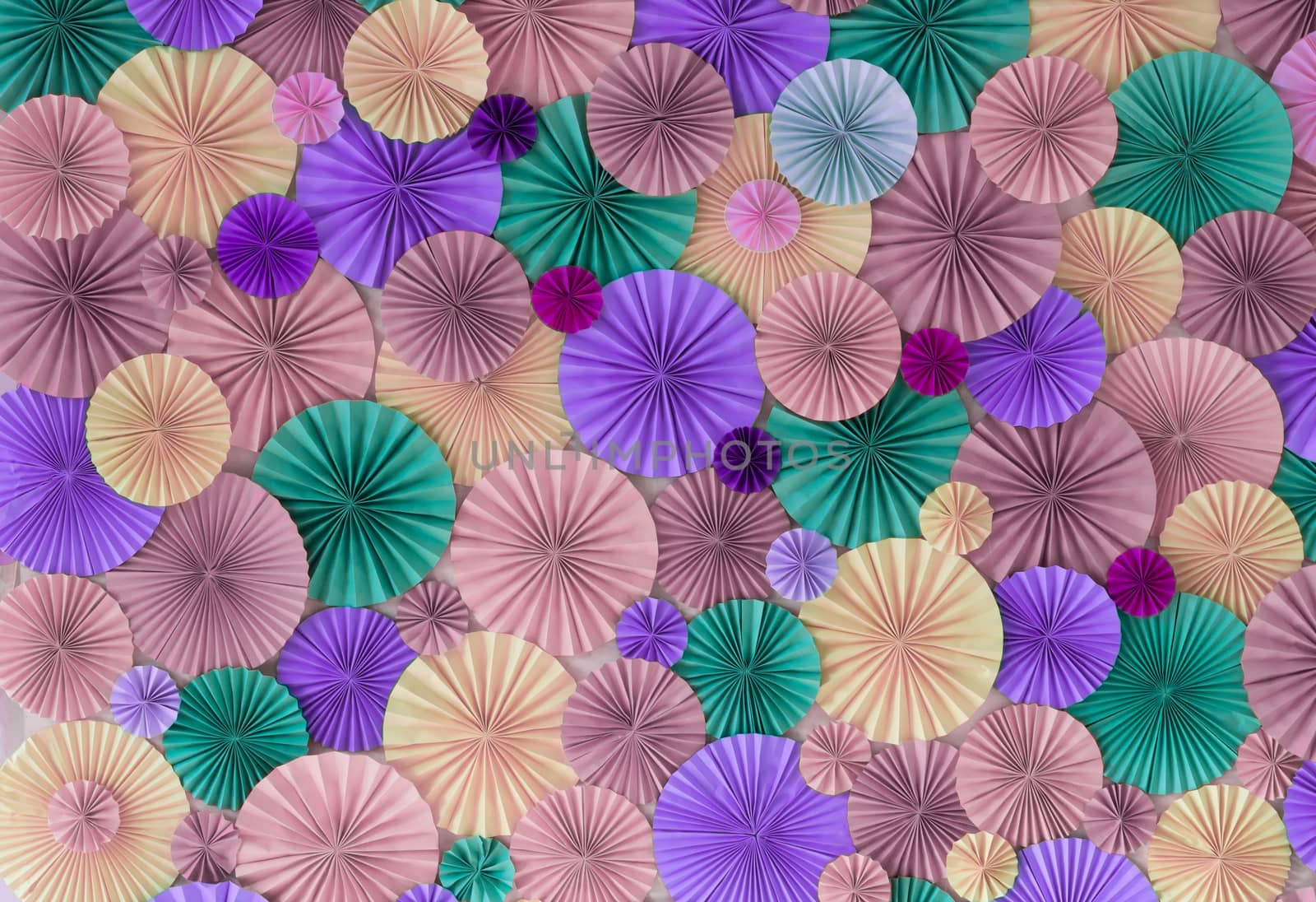 Romantic colorful celebration background wall with multicolored paper circles of pink, lilac, purple, green and beige colors