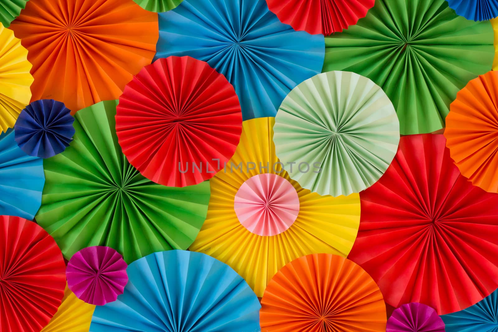 Colorful birthday celebration background wall with multicolored paper circles of red, yellow, blue, orange, green colors