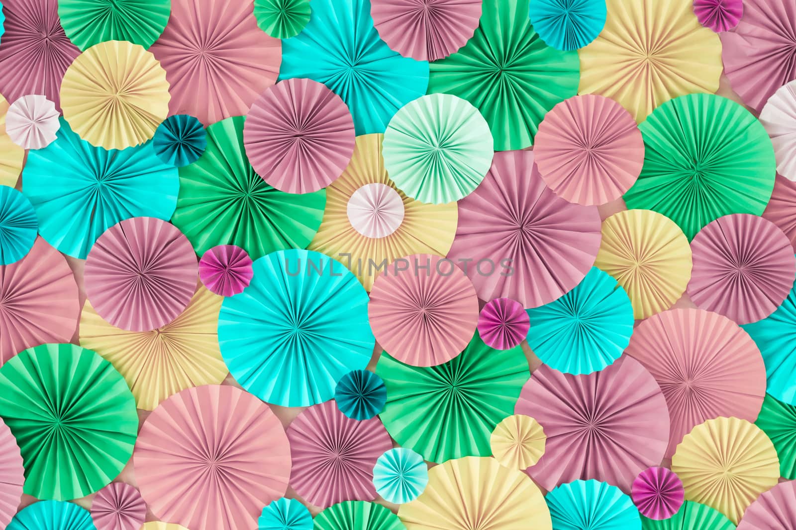 Colorful celebration background wall with multicolored paper circles of pink, lilac, yellow, green and blue colors