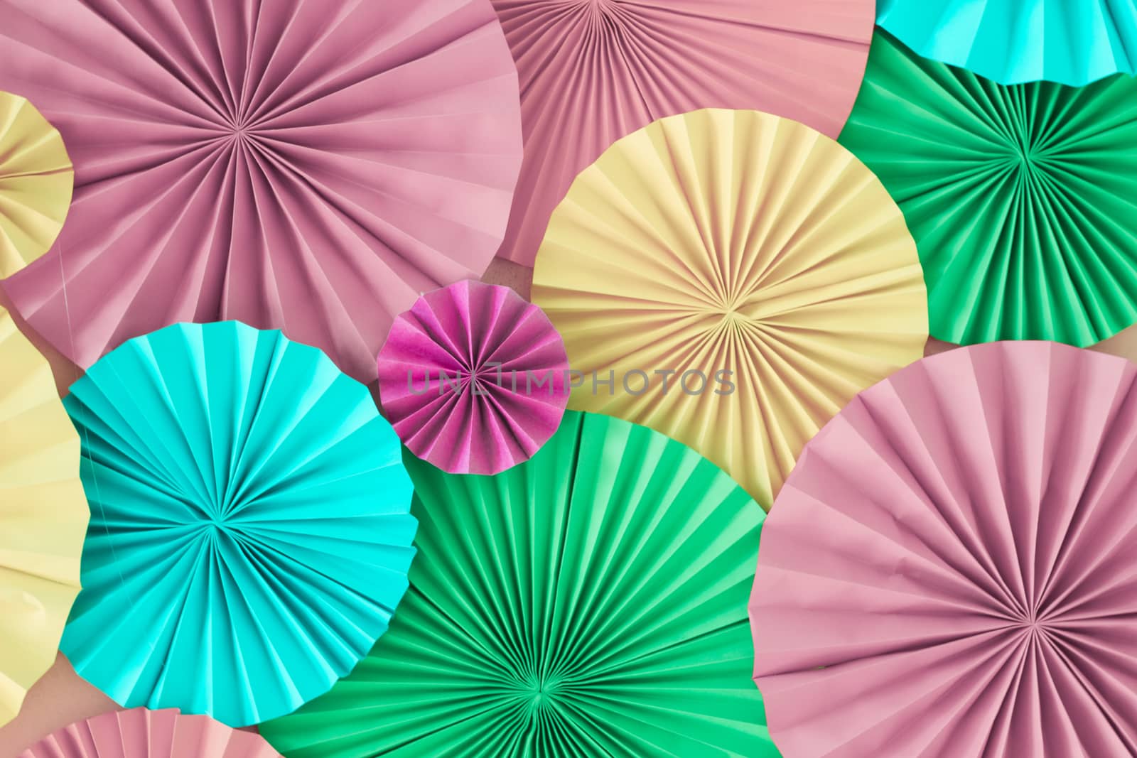 Colorful celebration background wall with multicolored paper circles of pink, lilac, yellow, green and blue colors