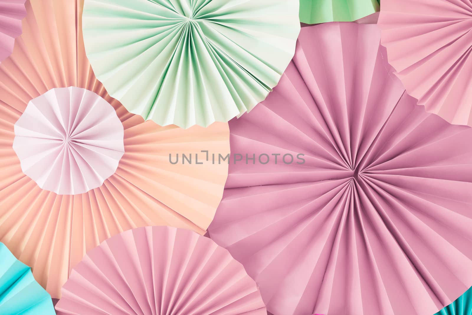 Colorful celebration background wall with multicolored paper circles of pink, beige, yellow