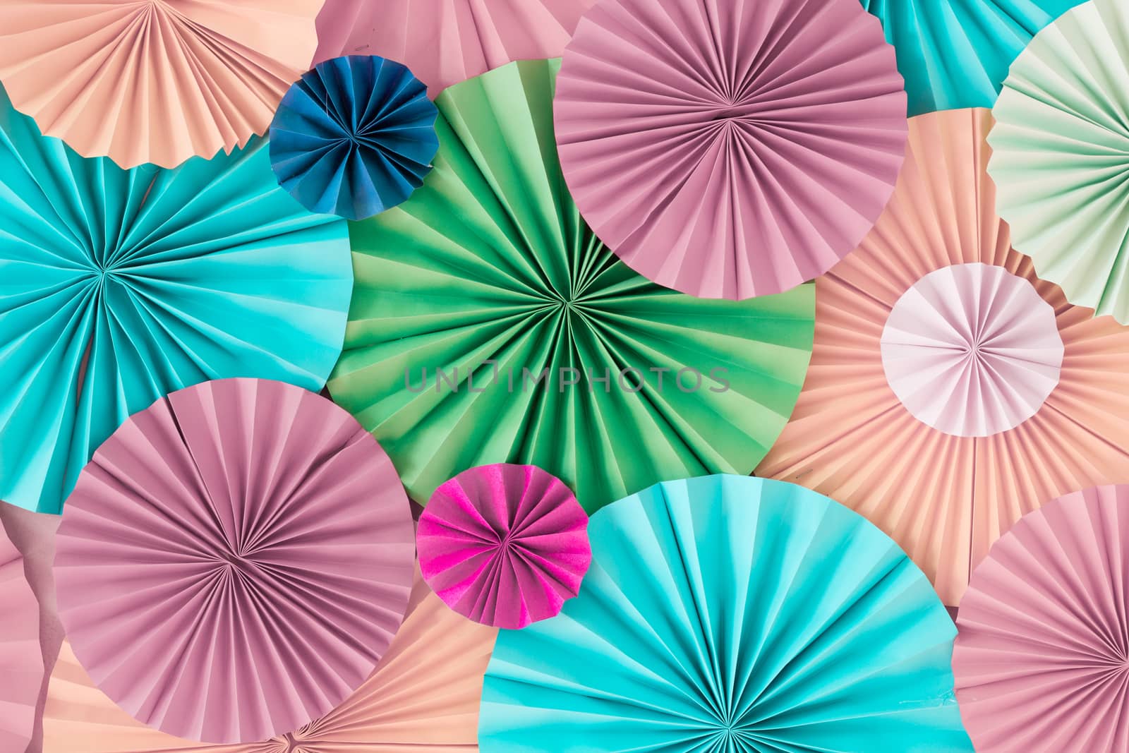 Colorful celebration background wall with multicolored paper circles of pink, beige, yellow, green and blue