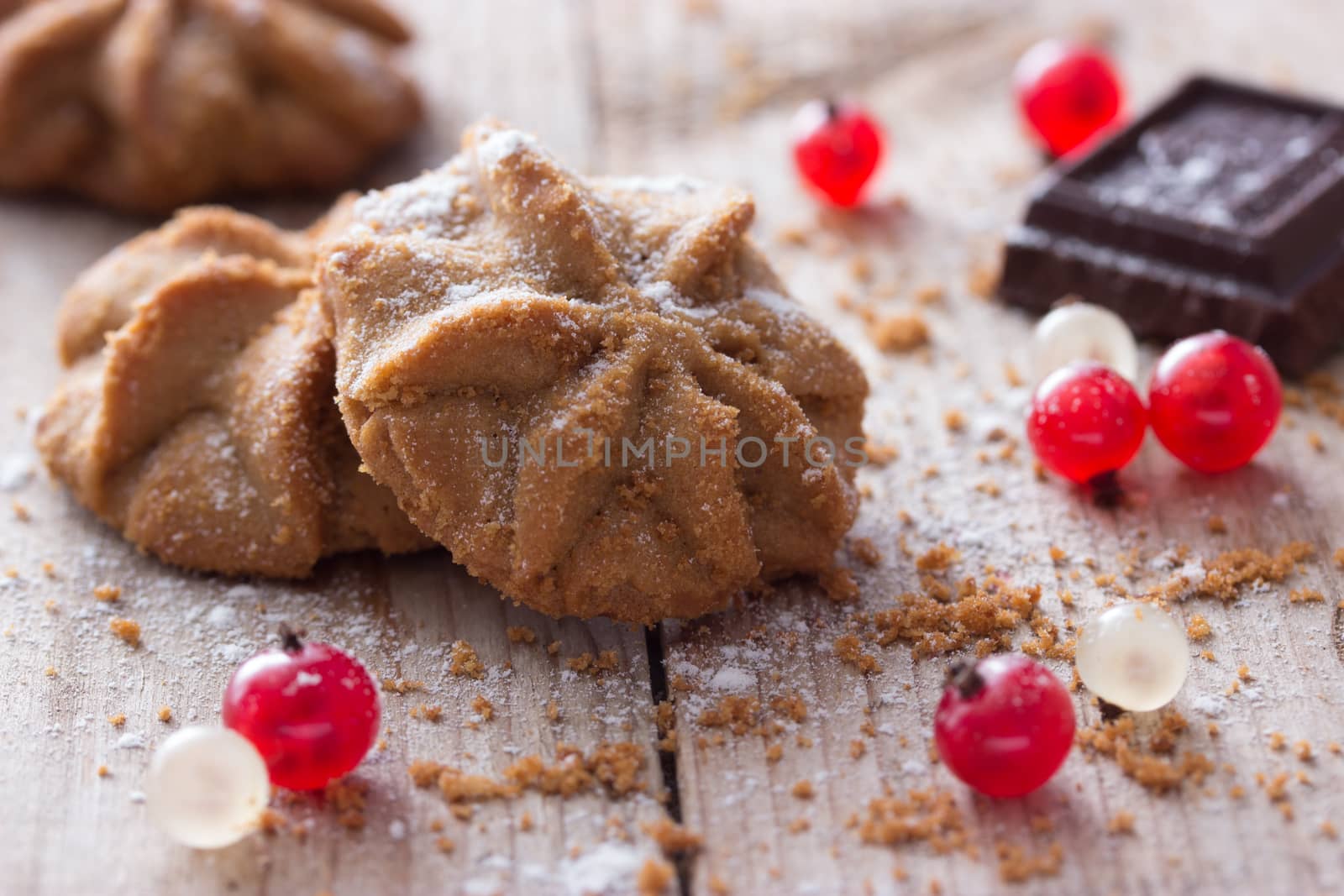 cookies with red berries on wooden table