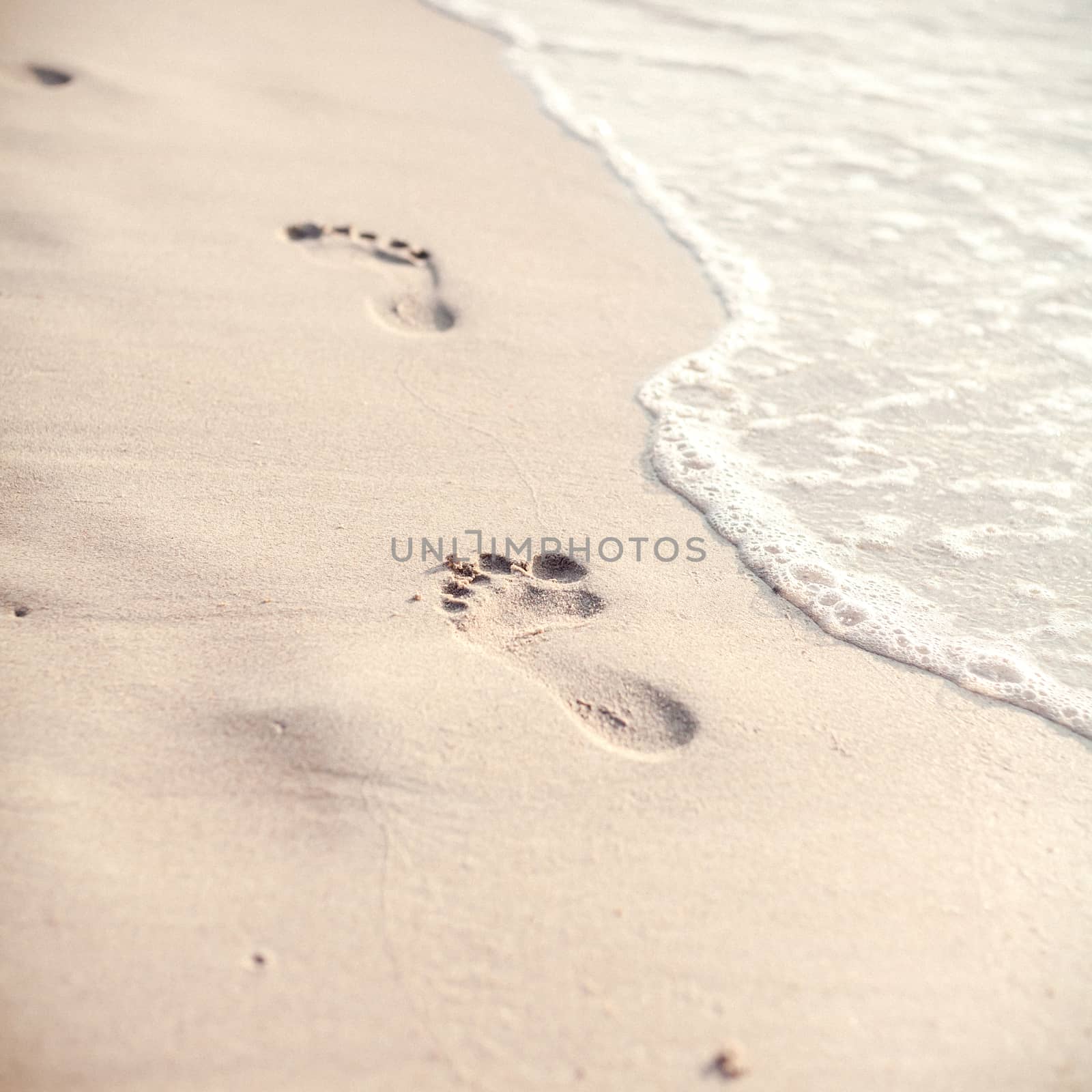 Soft focus and tone of footprints on the tropical beach sand wit by kerdkanno