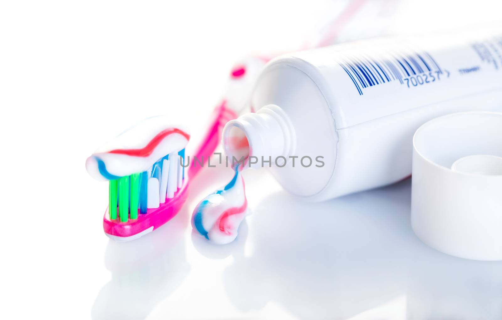 toothbrush with toothpaste close-up on white background