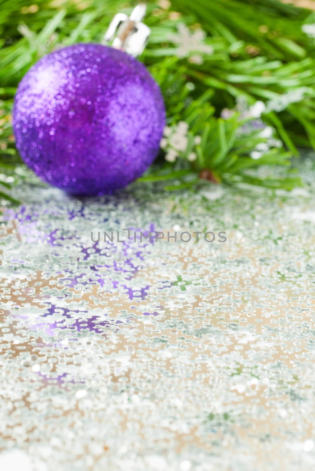 fir tree branch and Christmas toys bauble and snow flares confetti with copy space. Vertical orientation. Focus on foreground. Shallow DOF. Vertical orientation. Mock up for your design