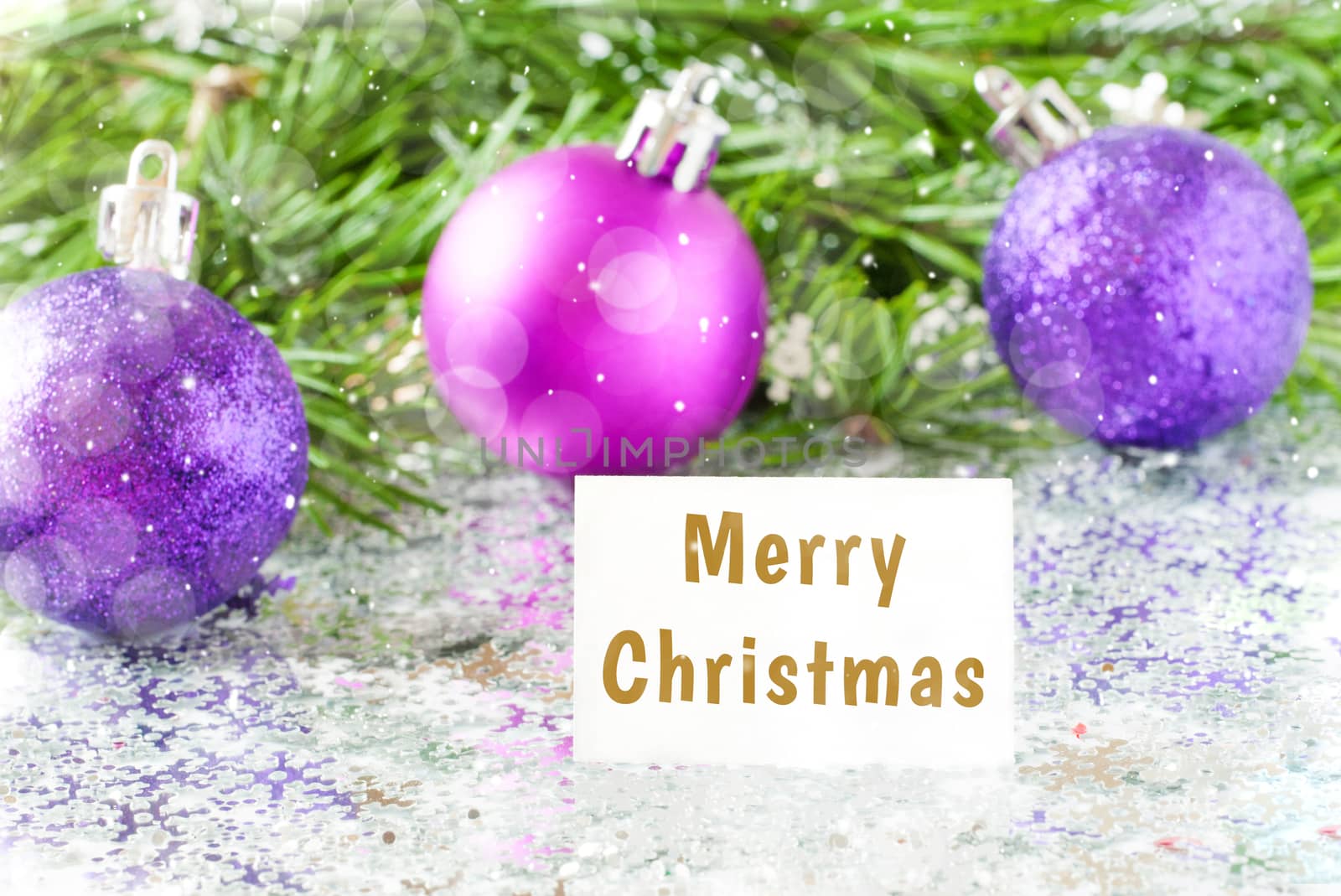 Fir tree branch and christmas toys bauble and snow flares confetti with Merry christmas text lettering. Merry christmas concept