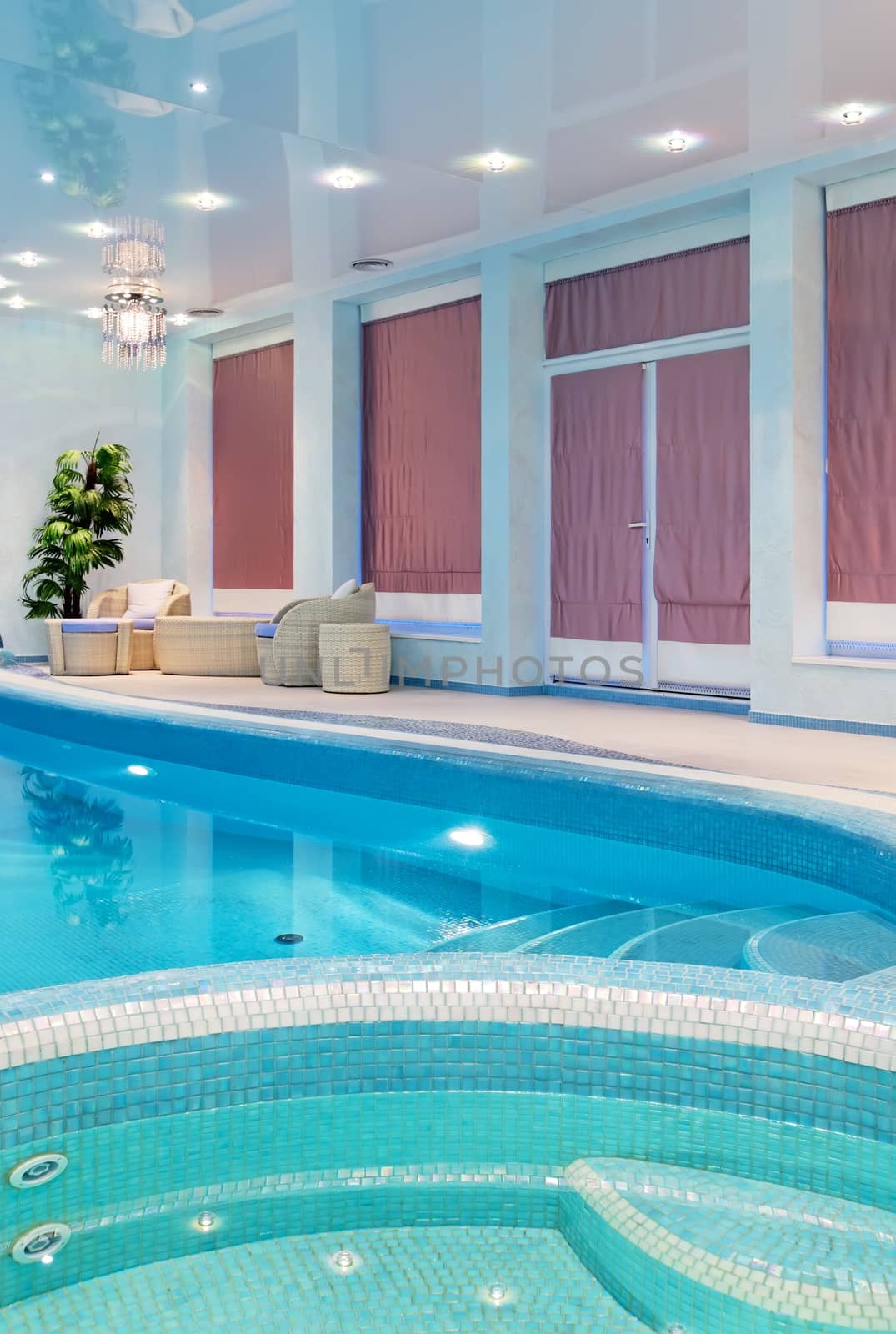 Relaxation spa zone near blue mosaic swimming pool 