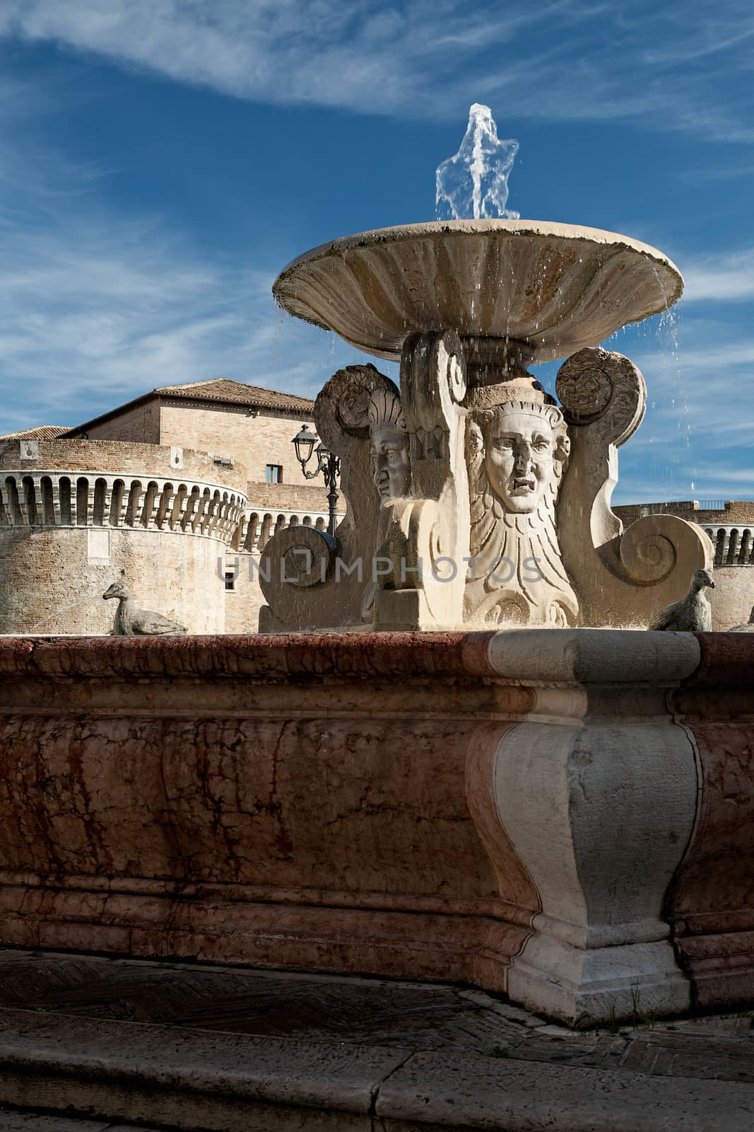 The ancient fountain in front of medieval fortress in Senigallia