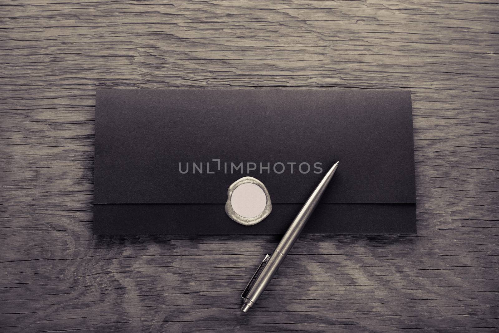 envelope with stamp and pen on the wooden table