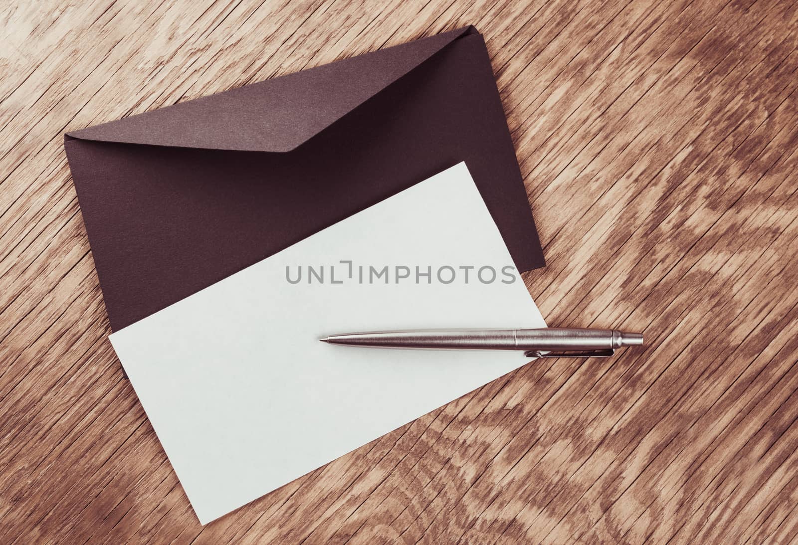 envelope with blank and pen on the wooden table