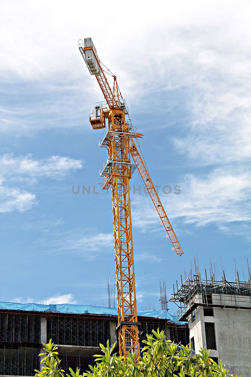 Construction site with crane and building on sky background, construction of the new building, construction crane