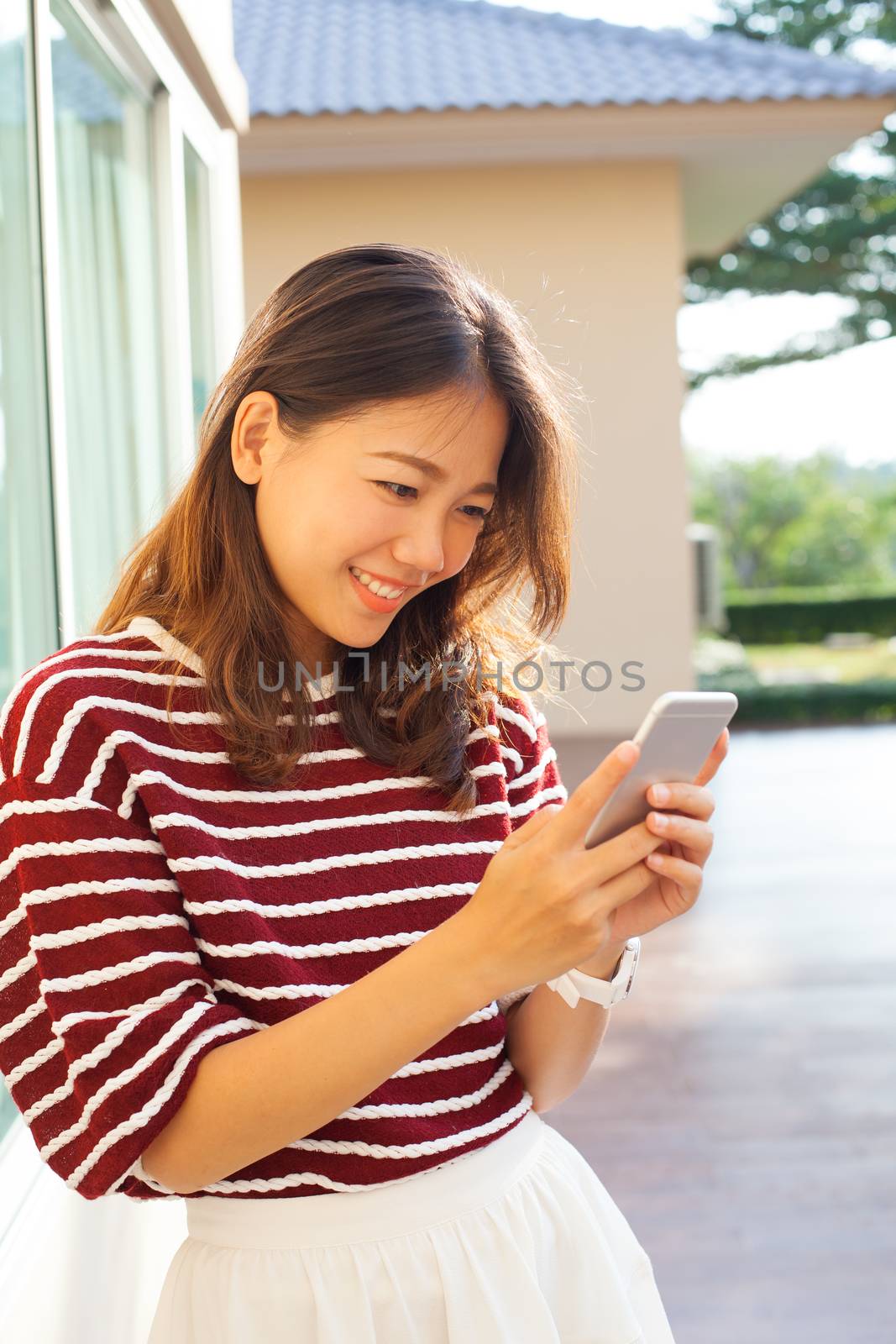 portrait of beautiful young woman reading message in smart phone use for modern people digtal life in connecting technology