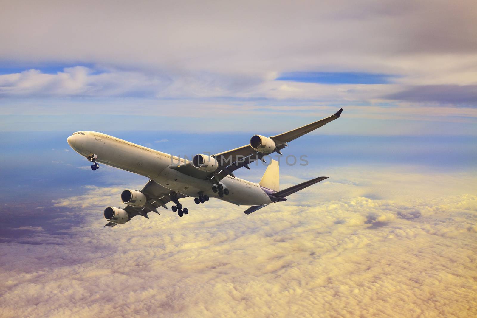 passenger jet  plane flying over cloud by khunaspix