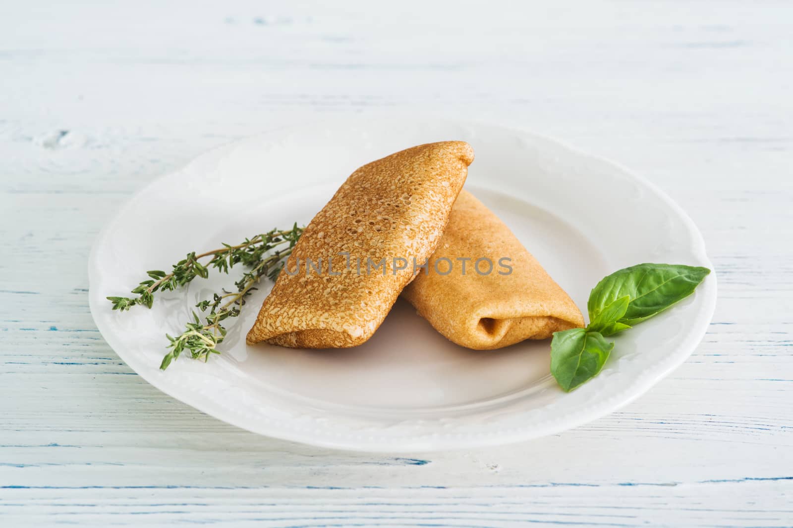 Stuffed pancakes on wooden background by kzen