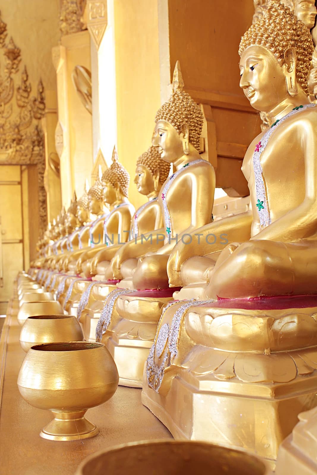 Golden monk's alms bowl and golden buddha statue at Paknam Jolo Temple, Bangkhla, Thailand