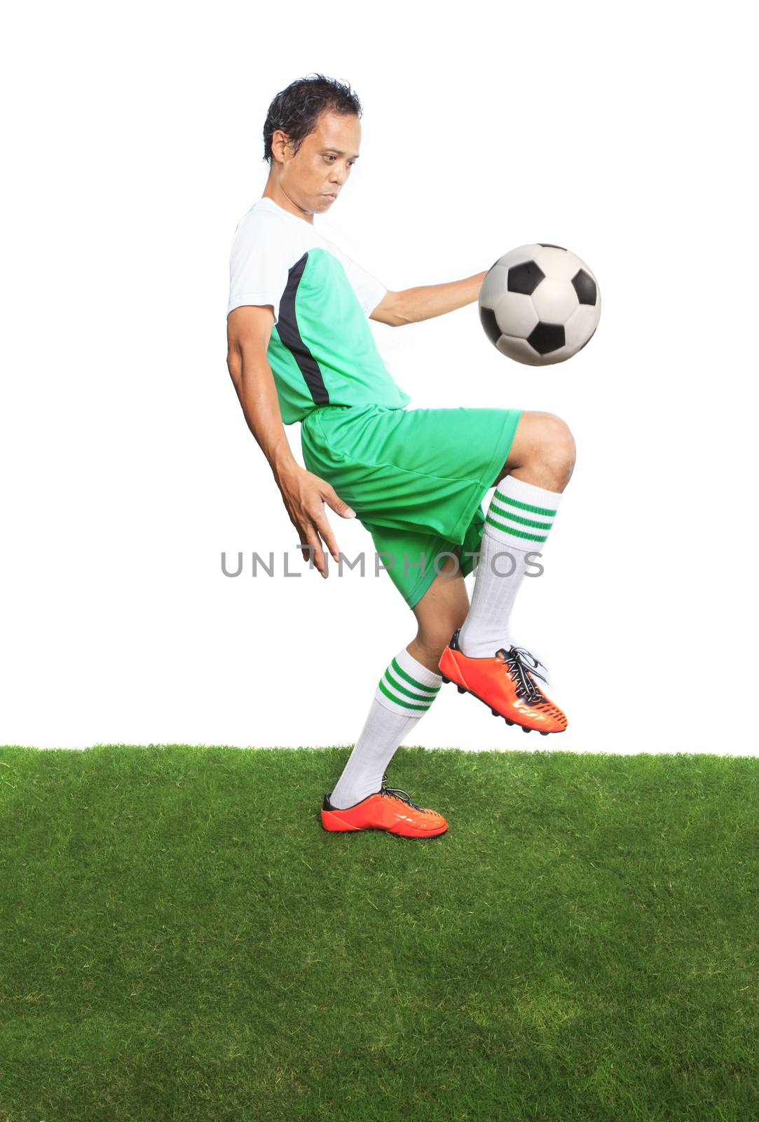 portrait of football ,soccer players playing soccer ball on gree by khunaspix