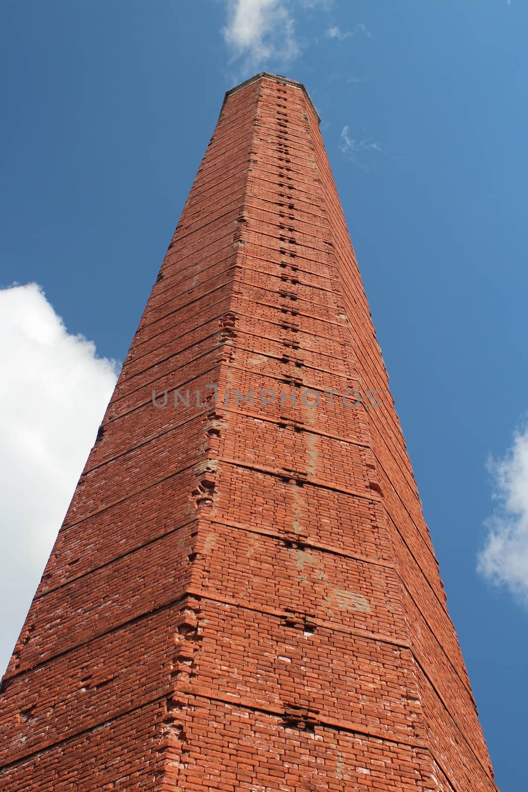 high smokestack of red brick hexagon