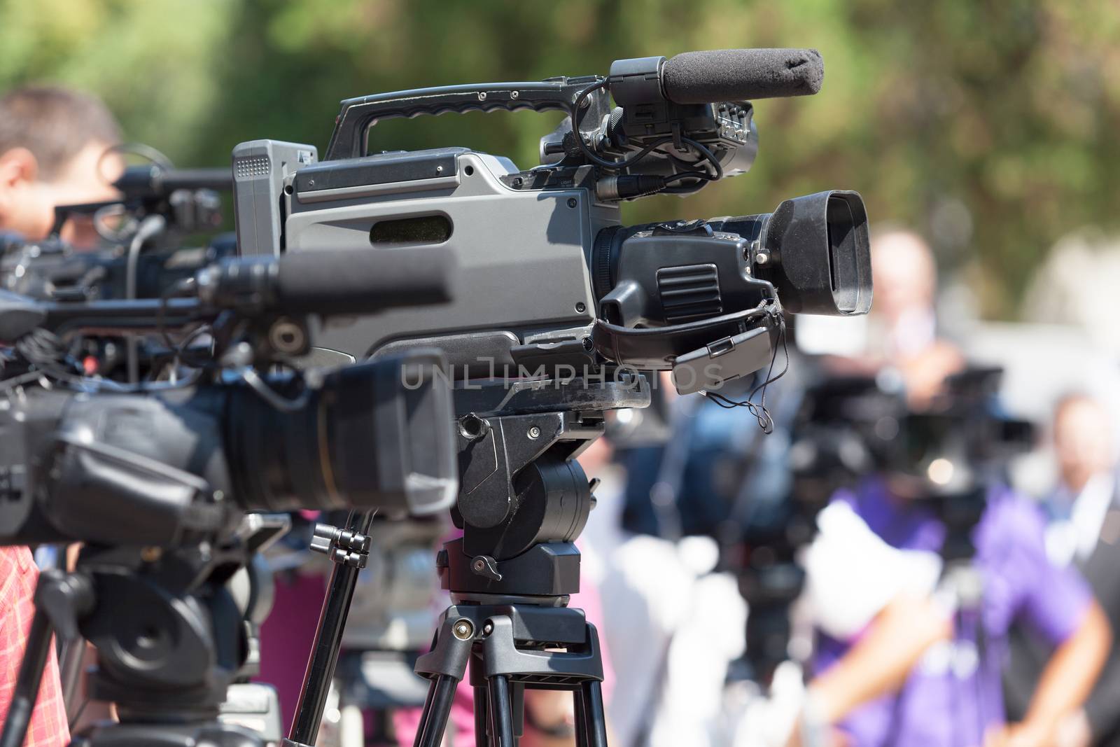 Press conference. Television camera in focus against blurred bac by wellphoto
