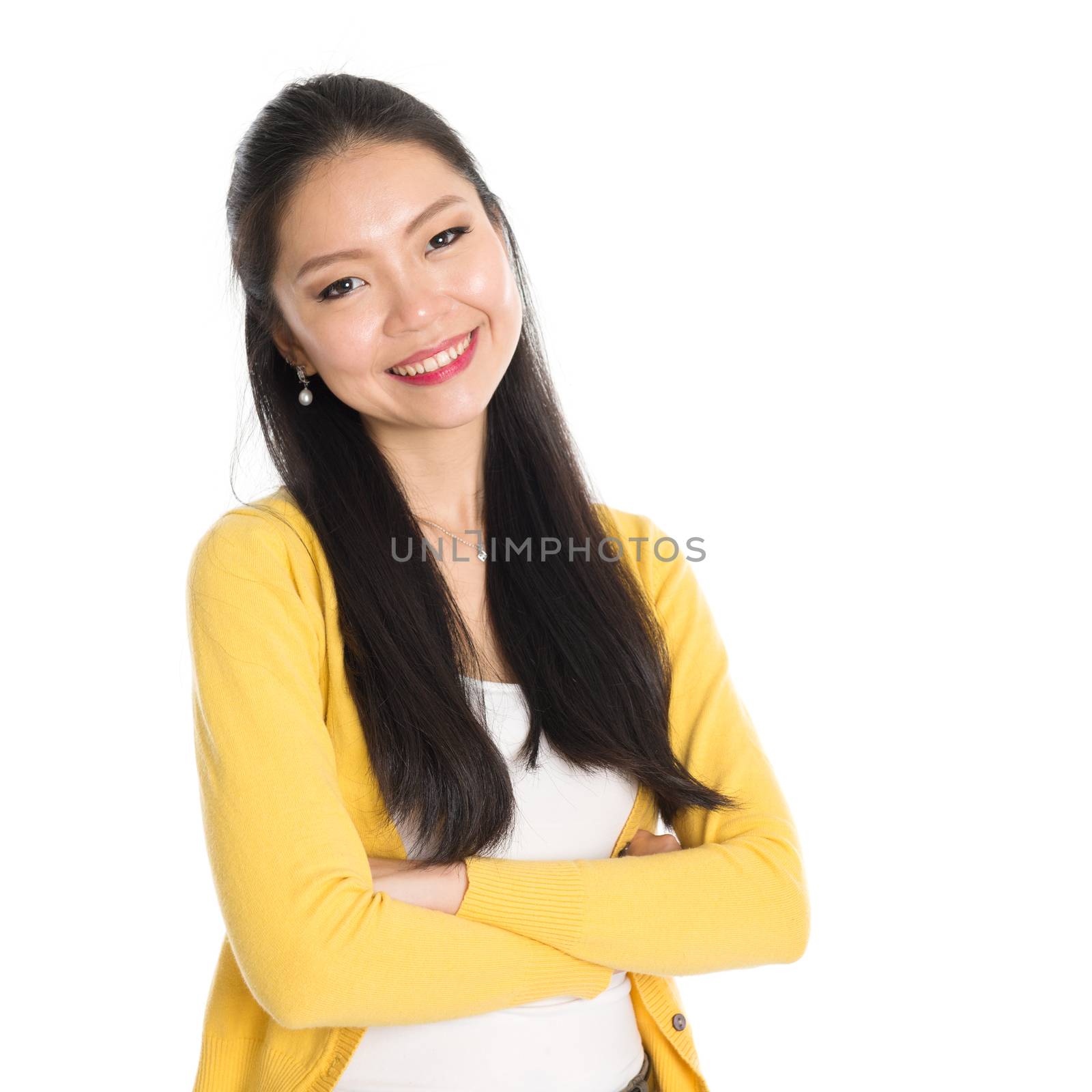 Portrait of Asian woman, smiling looking at camera, standing isolated on white background.