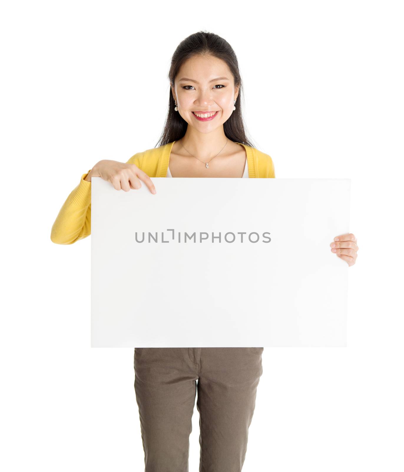 Portrait of casual Asian female hand holding blank white paper card and pointing on it, isolated on white background.